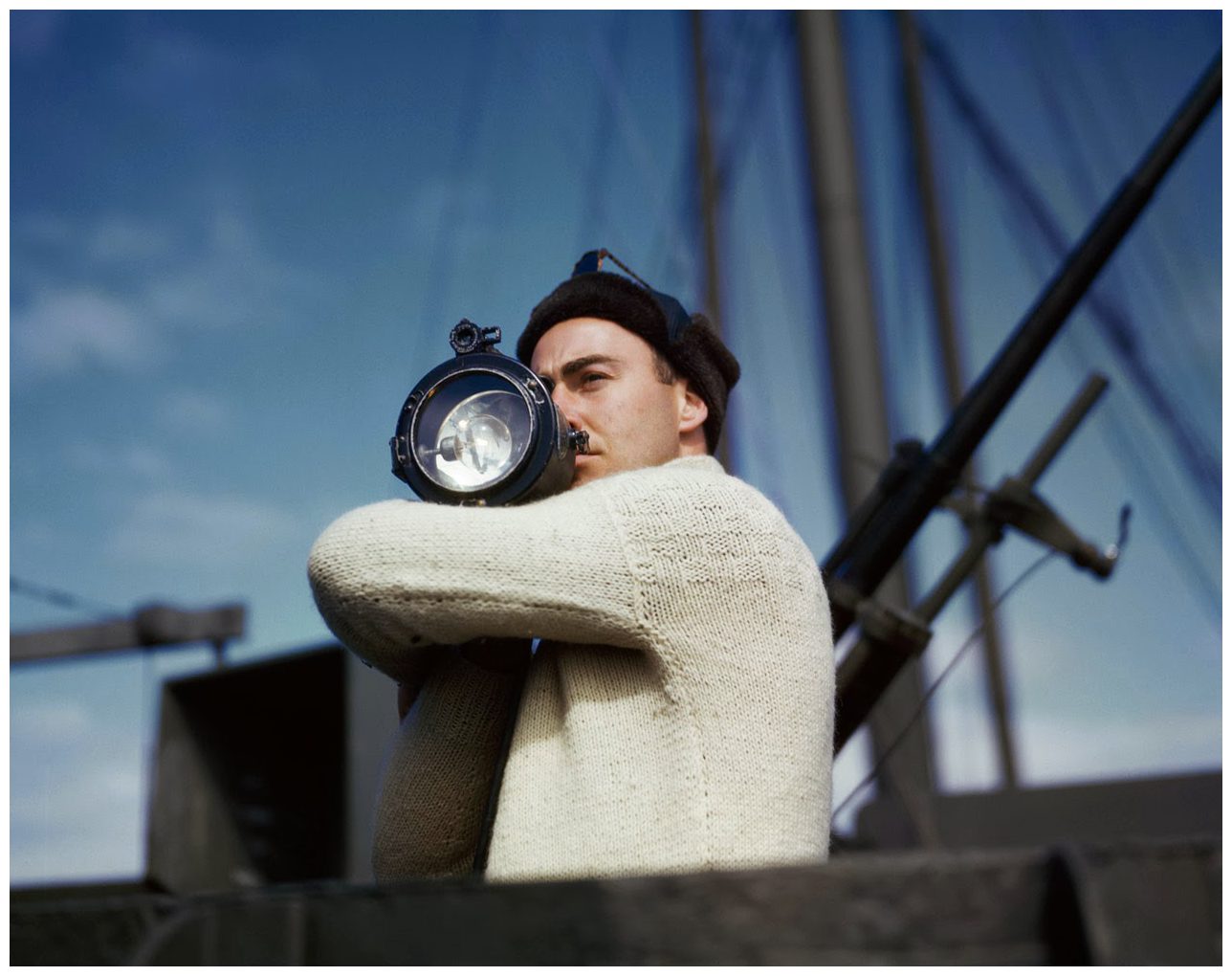 a-crewman-signals-another-ship-of-an-allied-convoy-across-the-atlantic-from-the-us-to-england-1942-photo-robert-capa