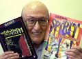 epa000341221 US comic legend Will Eisner poses with two comics of "The Spirit," a masked comic book hero he created in the 1930s, in this file photo taken 09 May 2003 in Barcelona. Eisner died Monday 03 January 2005 at Florida Medical Center in Lauderdale Lakes of complications from a quadruple bypass heart surgery last month. EPA/Alberto Estevez